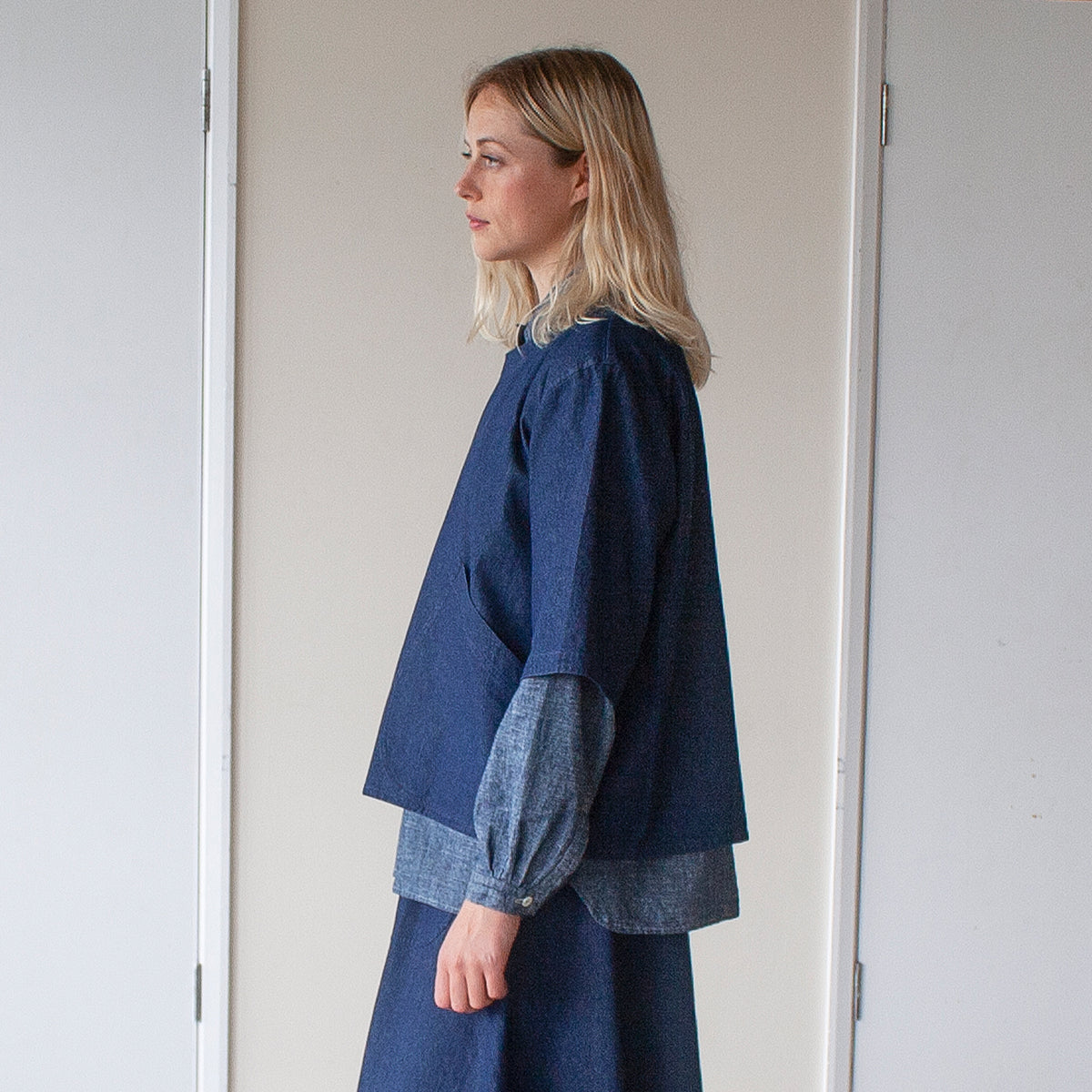 she view of a blonde woman wearing a simple denim over top