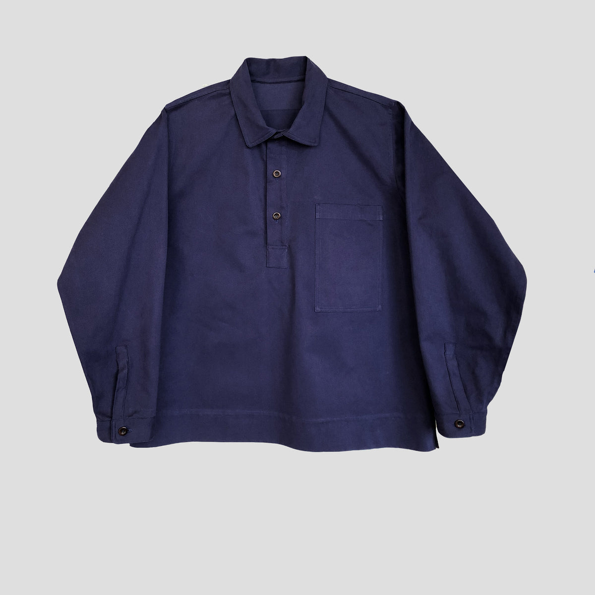 Navy blue shirt with a collar on a light gray background